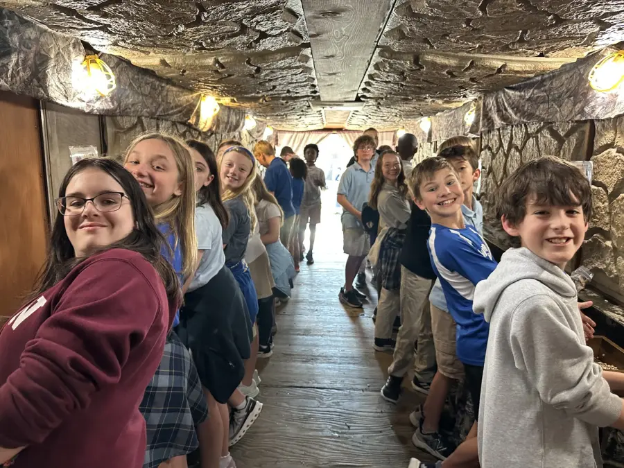 Students gathered inside the stone-sifting activity space