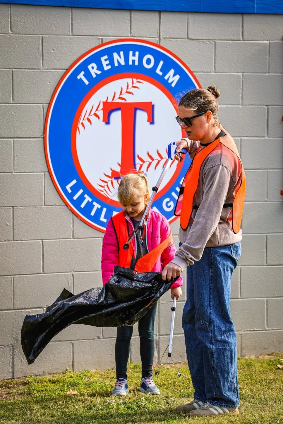 Students collecting litter at Trenholm Park Little League